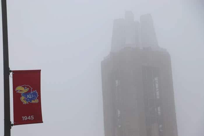 top of campanile and ku flag in fog