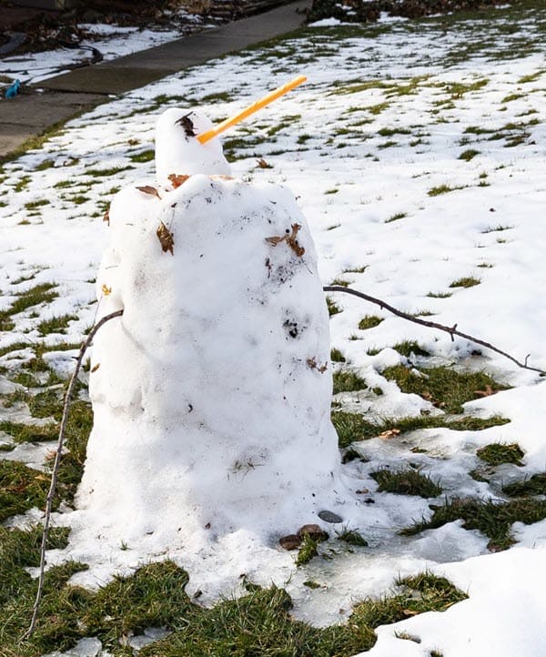 small snowperson with stick arms