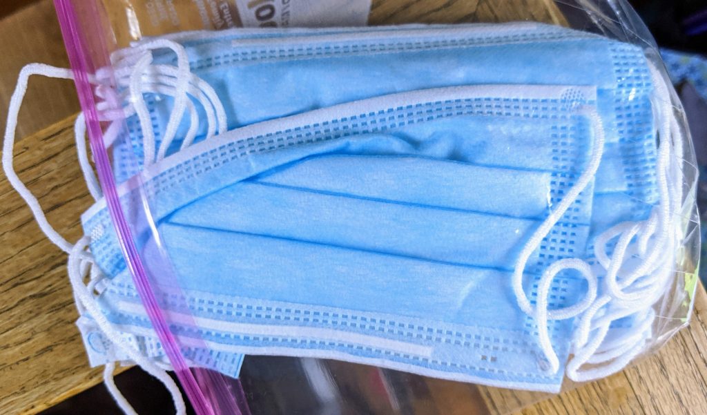 blue surgical masks inside a plastic bag